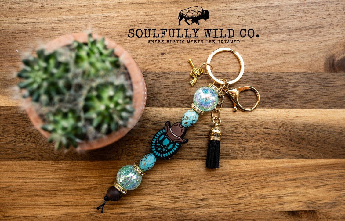 Wild Soul Keychain - Concho/Cowboy Hat, Turquoise, Black Tassel, Gold Pistol Charm