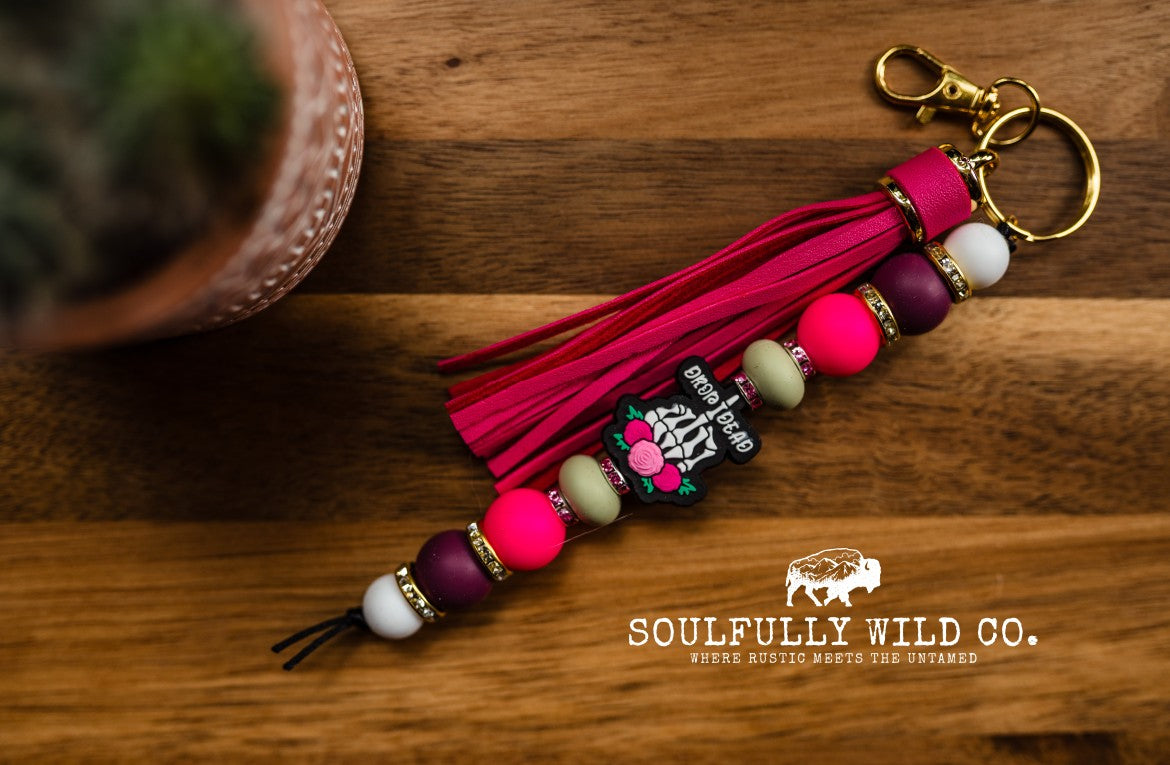 Wild Soul Keychain - "Drop Dead" Skelton Hand with Middle Finger & Flowers